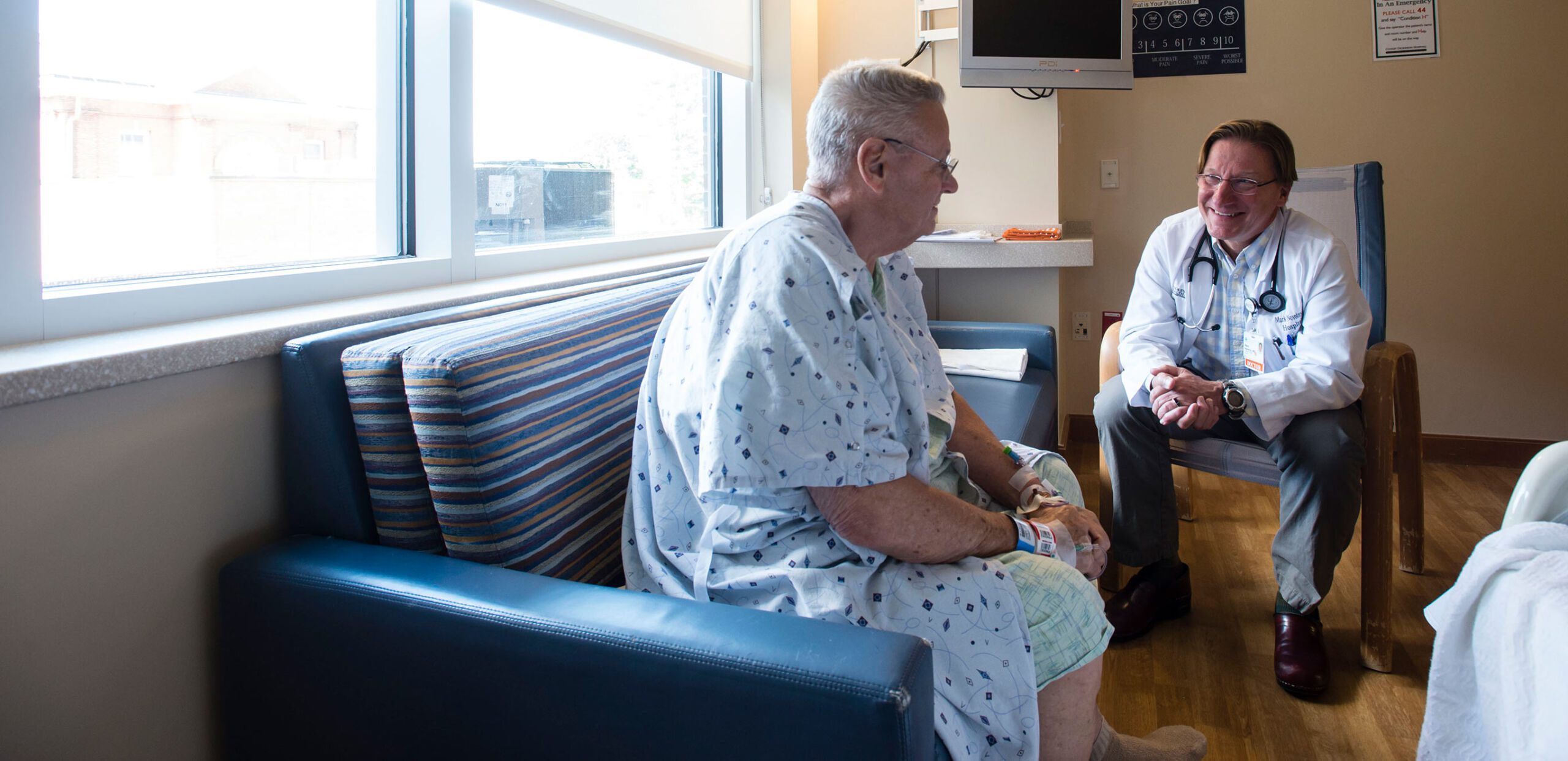 Hospitalist Mark Novotny, MD, talks with patient at Cooley Dickinson Hospital, Northampton, MA 01060