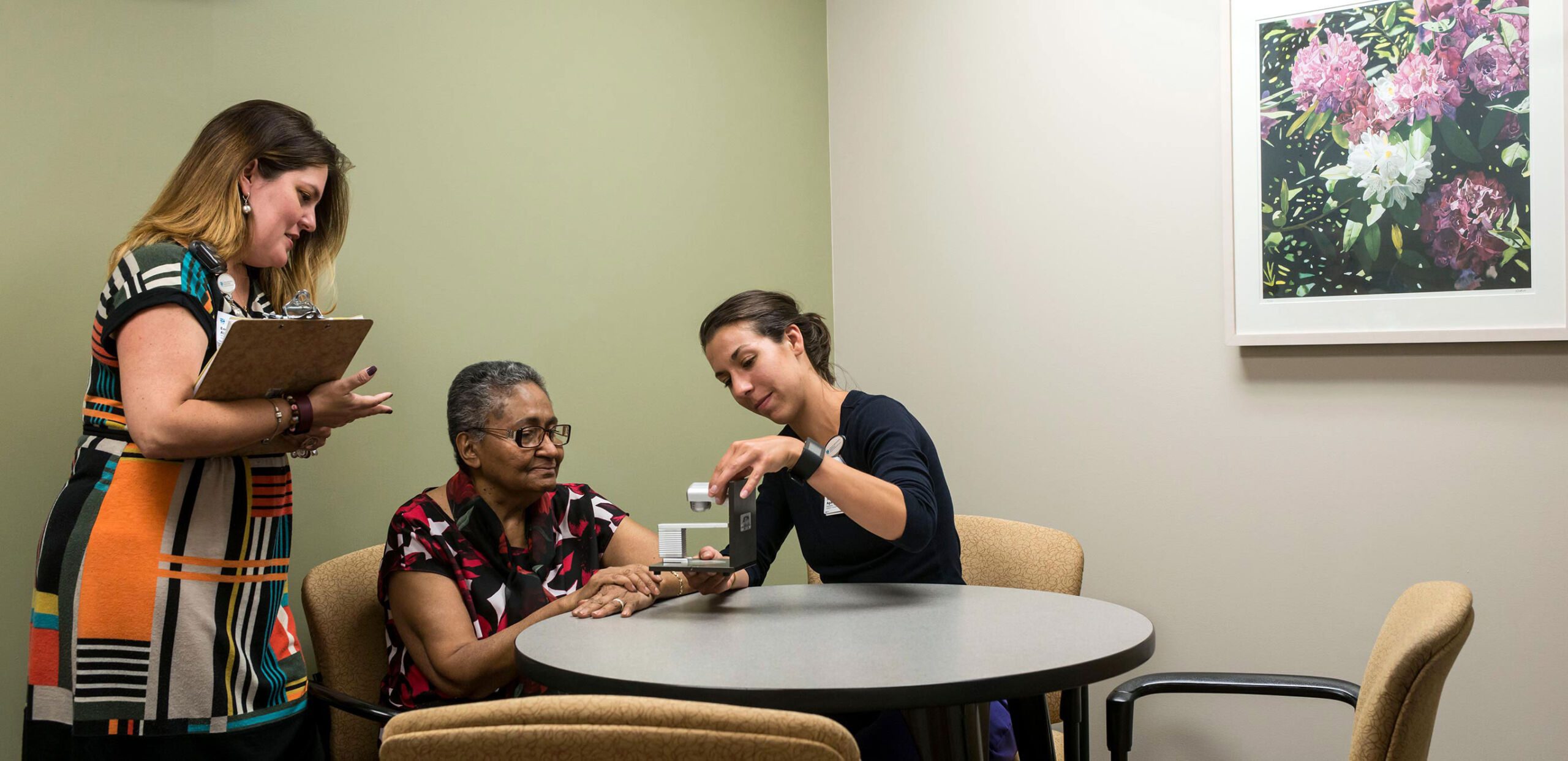 Staff in the Interpreter Services Department at Cooley Dickinson Hospital talk with a client.