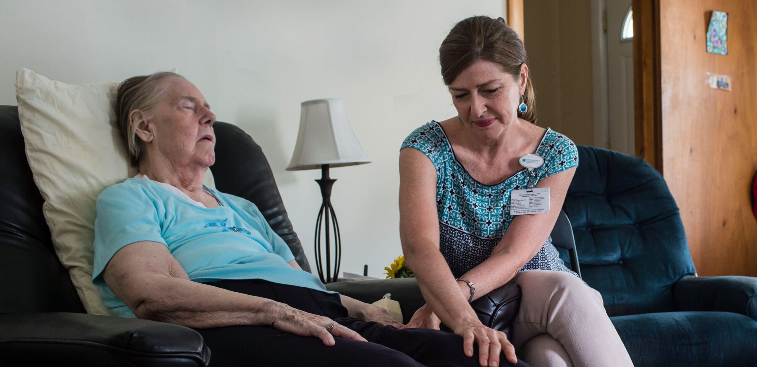 Visiting nurse comforts elderly client in her home, Cooley Dickinson Medical Group Visiting Nurses & Hospice, Northampton, MA 01060.