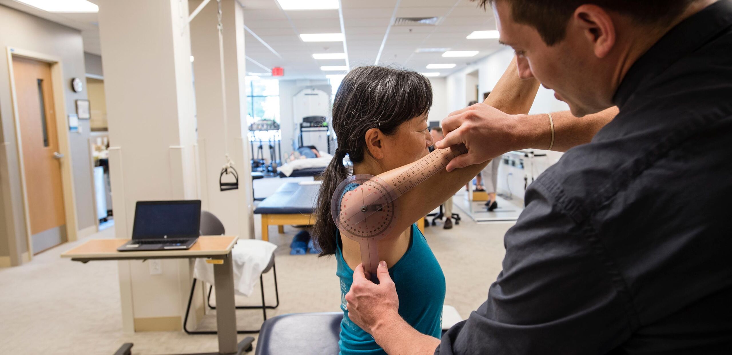 Physical therapist evaluates a female patient's range of arm motion at Cooley Dickinson Medical Group Rehabilitation Services, Northampton, MA 01060.