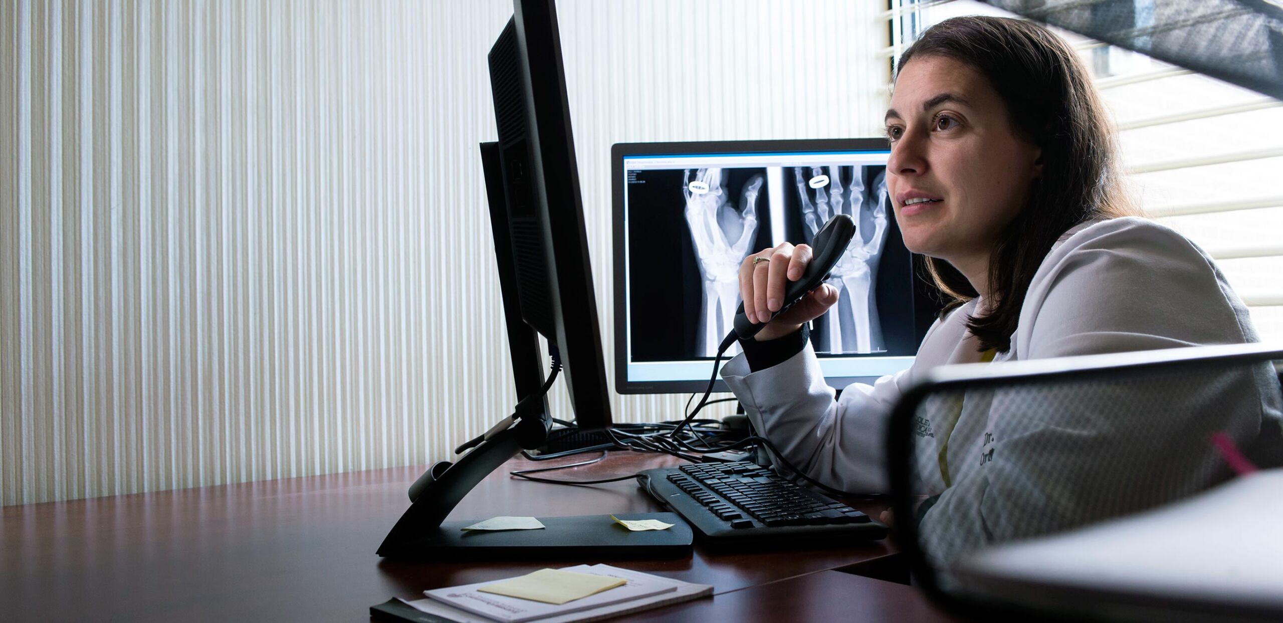 Orthopedist Teresa Pianta, MD, records her diagnosis of a patient's hand x-ray at Cooley Dickinson Medical Group Orthopedic and Sports Medicine, West Hatfield, MA 01088.