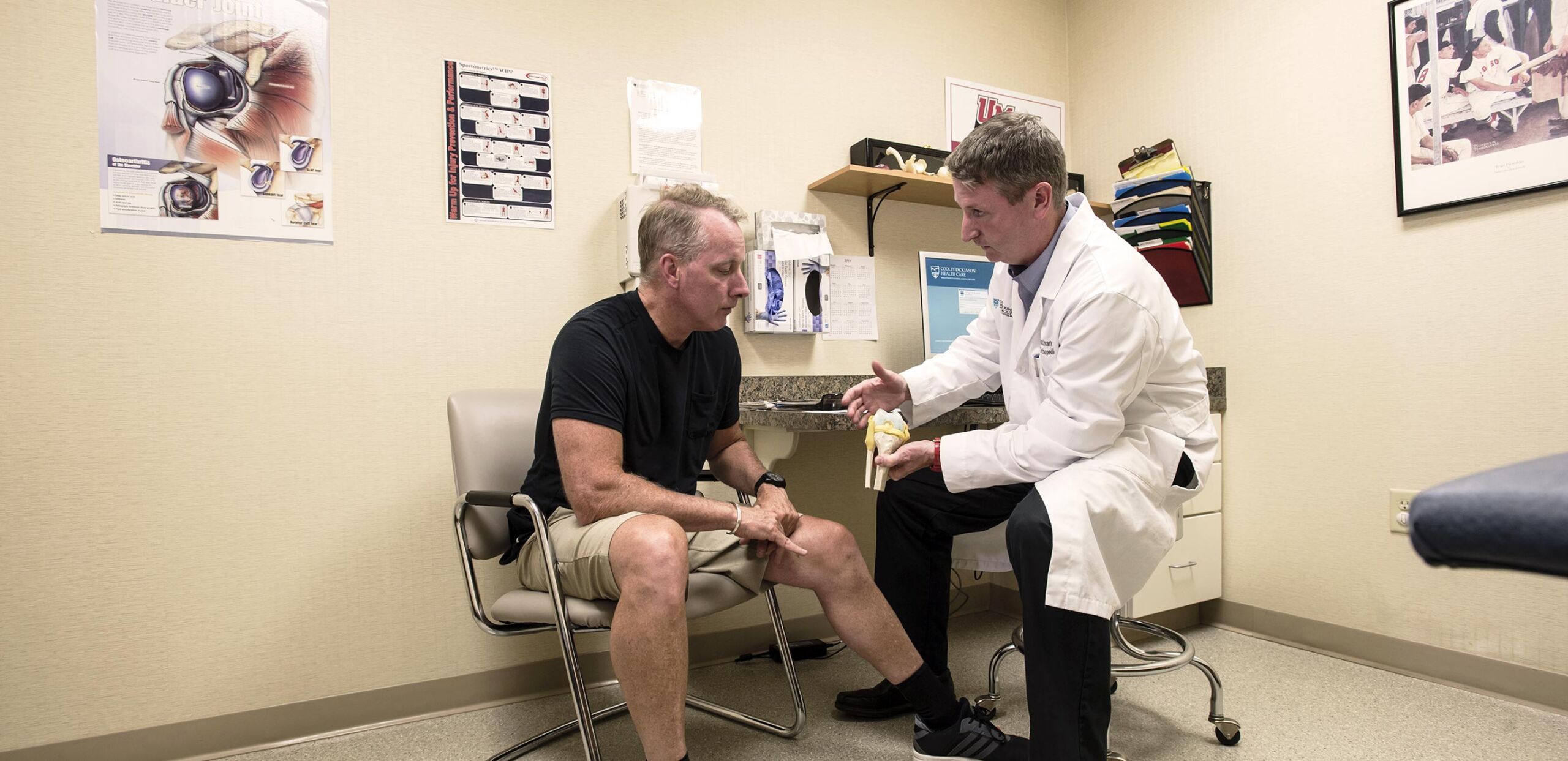 Chief of Orthopedic Surgery Jonathan Fallon, OD, talks with a patient about knee replacement at Cooley Dickinson Medical Group Orthopedic and Sports Medicine, West Hatfield, MA 01088.
