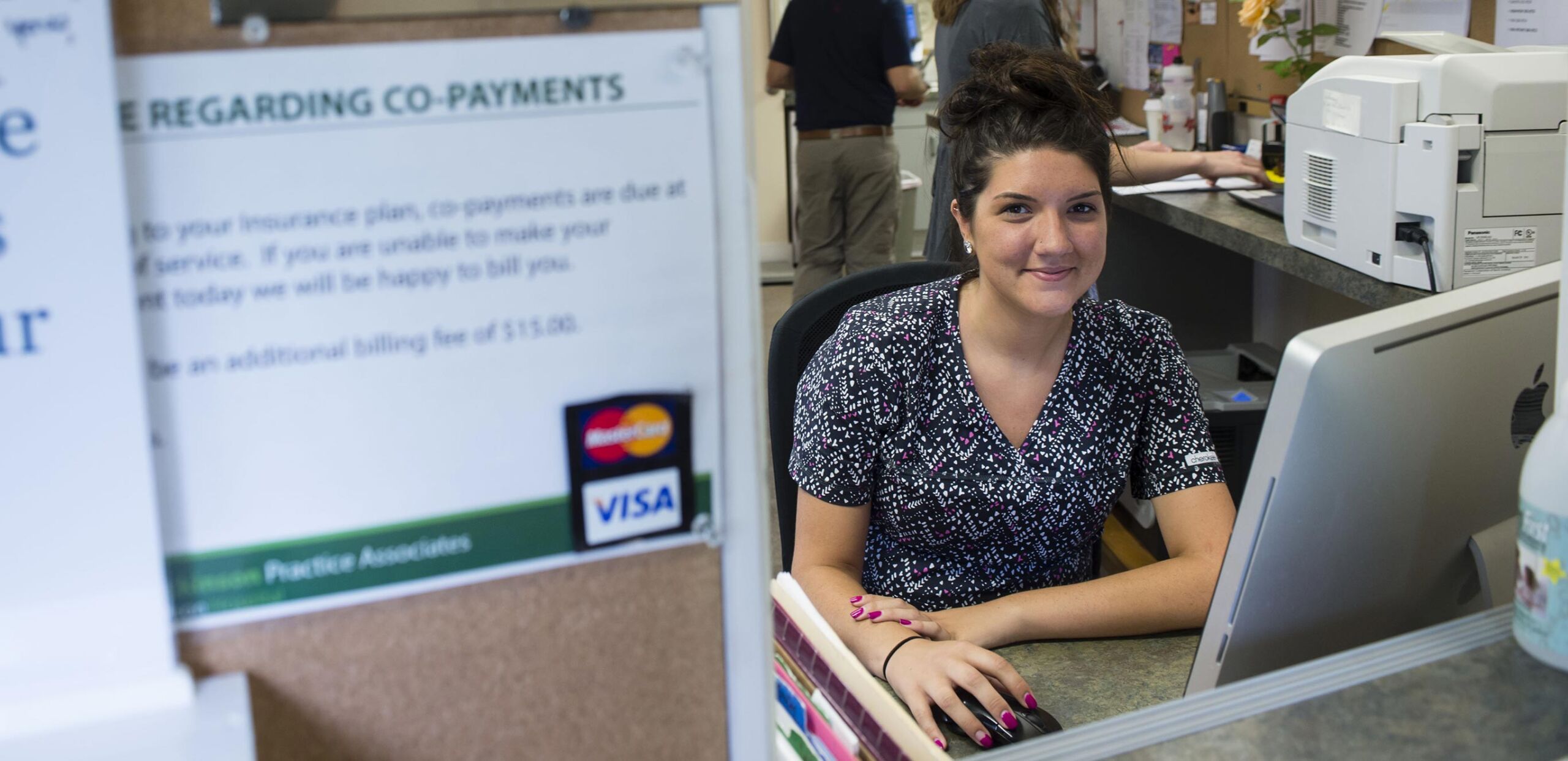 Smiling provider sits at her workstation at Williamsburg Internal Medicine, 14 Williams Street, Williamsburg, MA 01096, a Cooley Dickinson Medical Group Primary Care Practice.