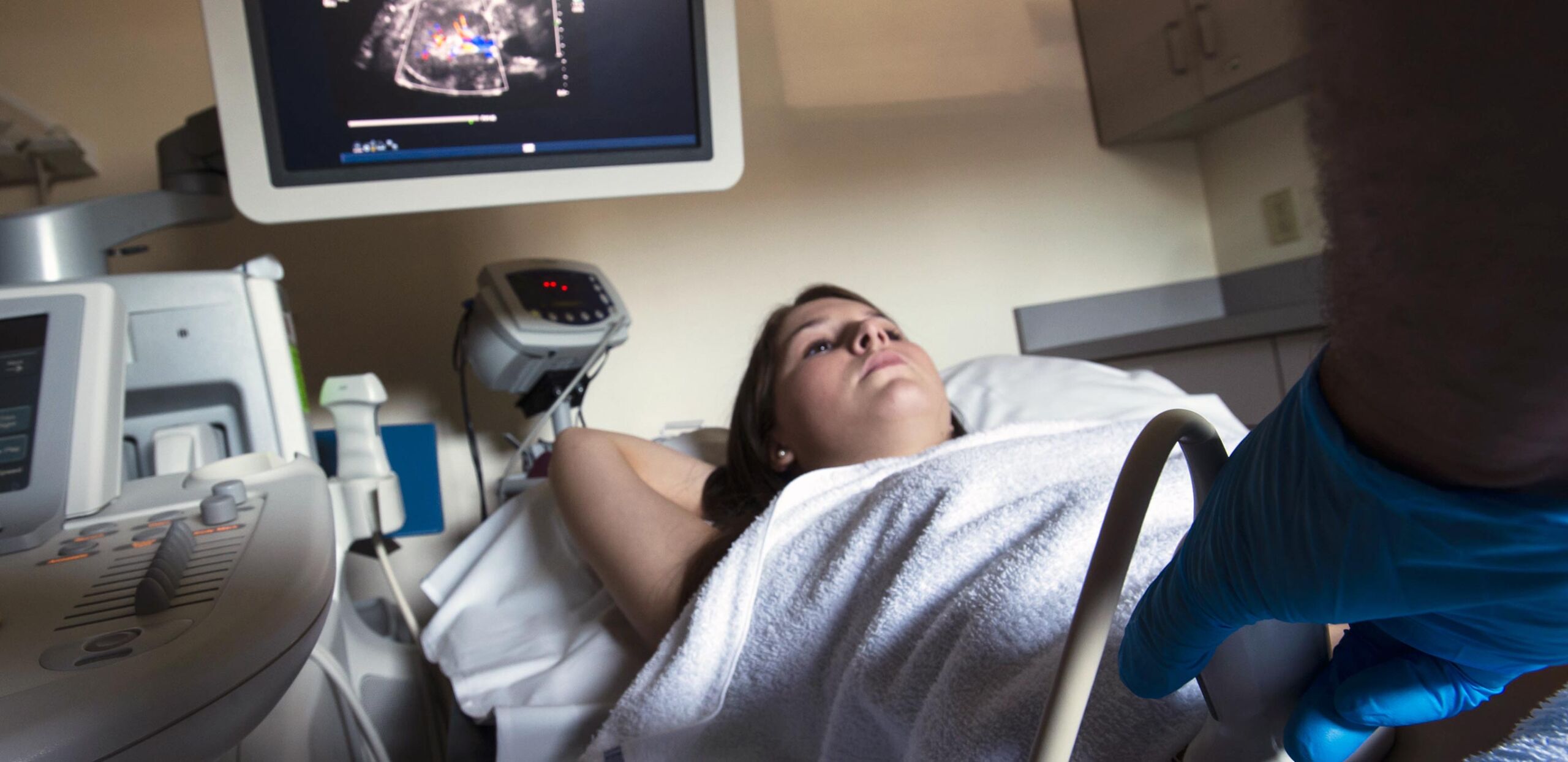 Technologist monitors display while performing ultrasound scan of female patient's torso at Cooley Dickinson Hospital, 30 Locust Street, Northampton, MA 01060.
