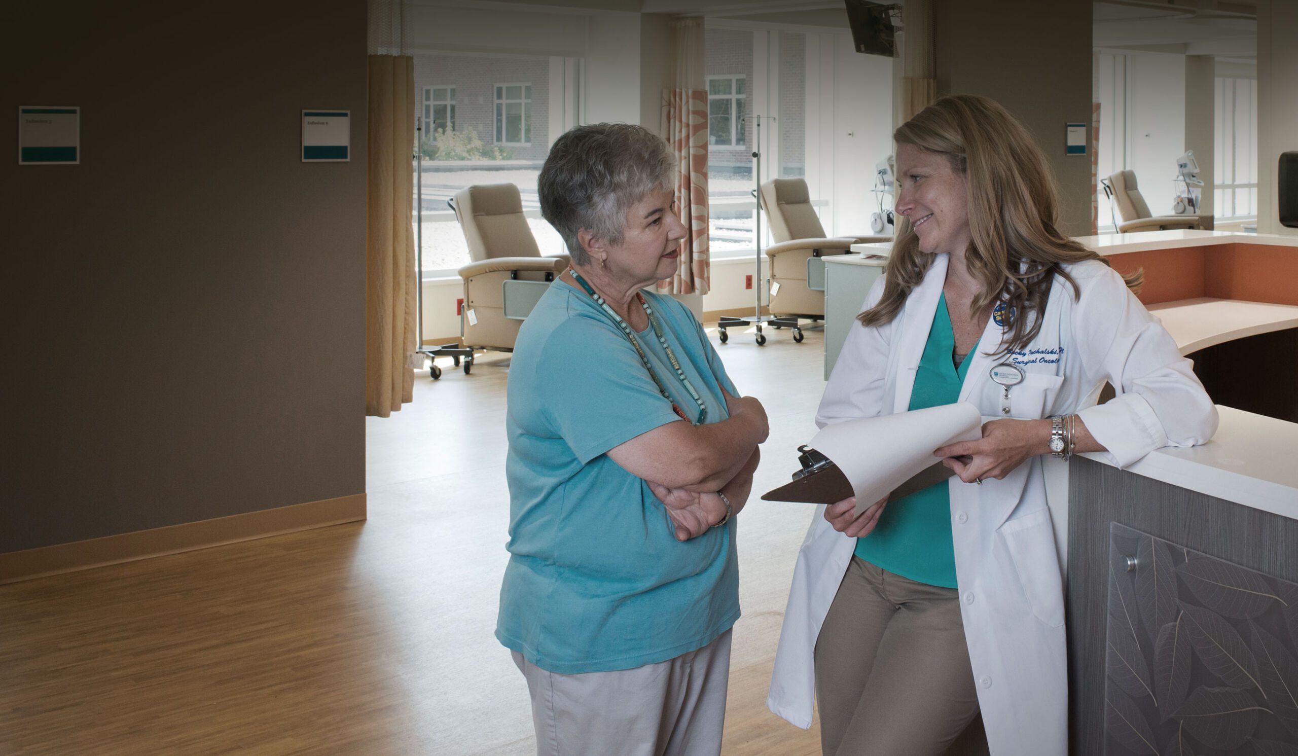 A family member confers with nurse Becky Puchalski near the infusion bays in the Mass General Cancer Center at Cooley Dickinson Hospital, 30 Locust Street, Northampton, MA 01060.