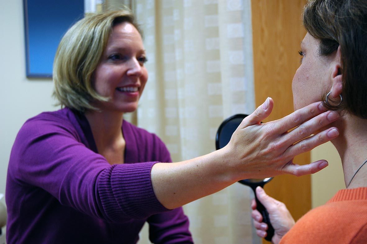 Plastic surgeon Simone Topal, MD, evaluates female patient for facial surgery, Cooley Dickinson Medical Group Plastic Surgery, Florence, MA 01062.