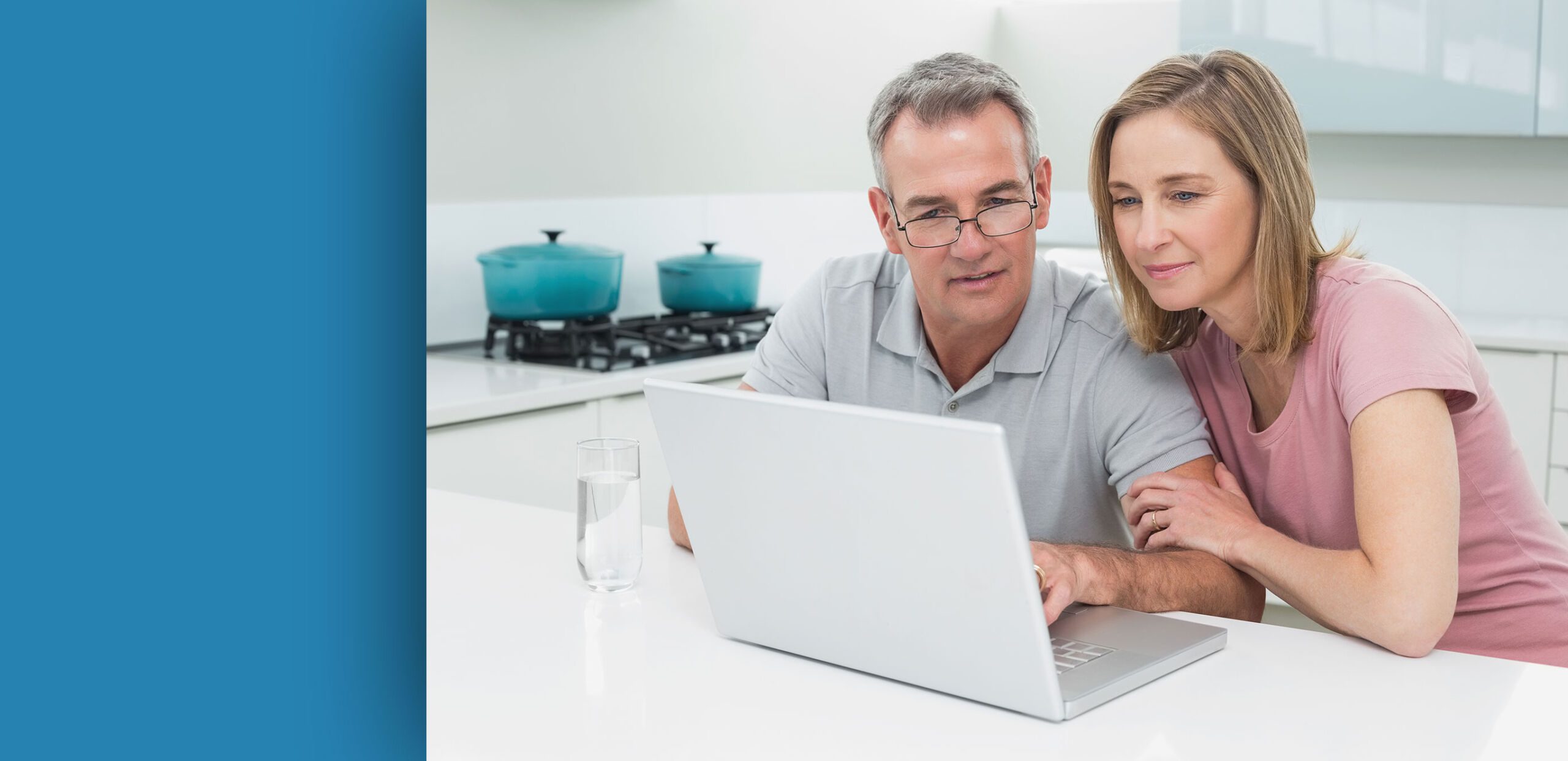 Man and woman looking at laptop computer in their kitchen, Cooley Dickinson Medical Group Plastic Surgery, Florence, MA 01062.