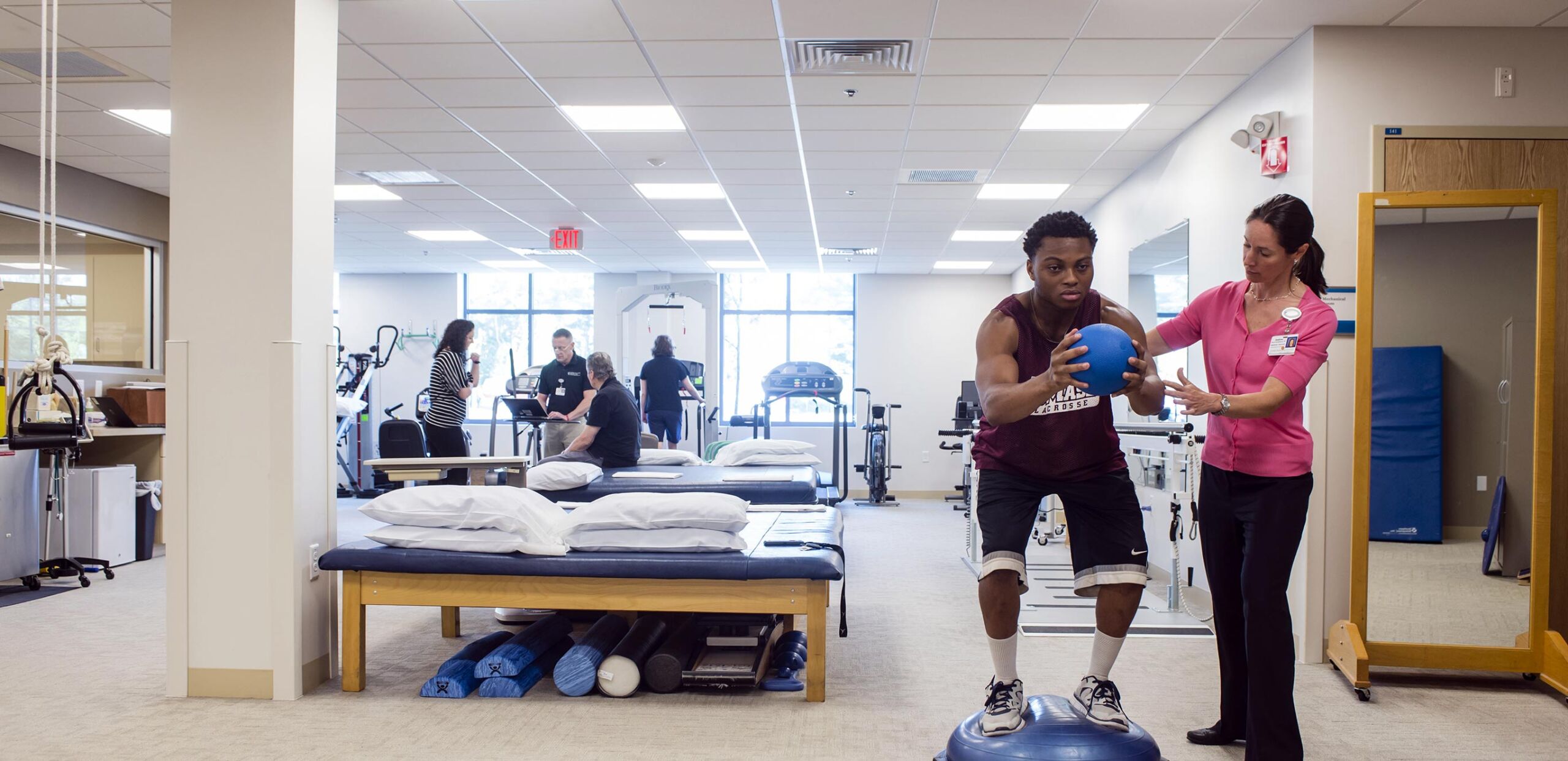 Female physical therapist helps male patient perform balance exercises, Rehabilitation Services at Cooley Dickinson Health Care include Physical Therapy, Occupational Therapy and Speech and Language Pathology.