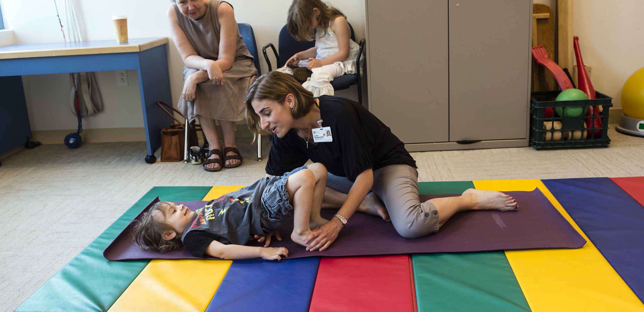 Occupational therapist works with young patient on floor exercises at Cooley Dickinson Rehabilitation Services, Northampton, MA 01060.