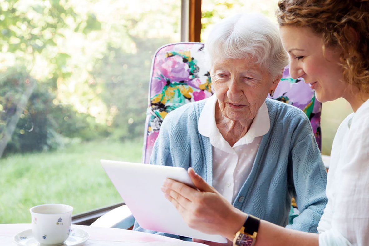 Social worker reviews forms with elderly client, Cooley Dickinson Medical Group, Northampton, MA 01060.