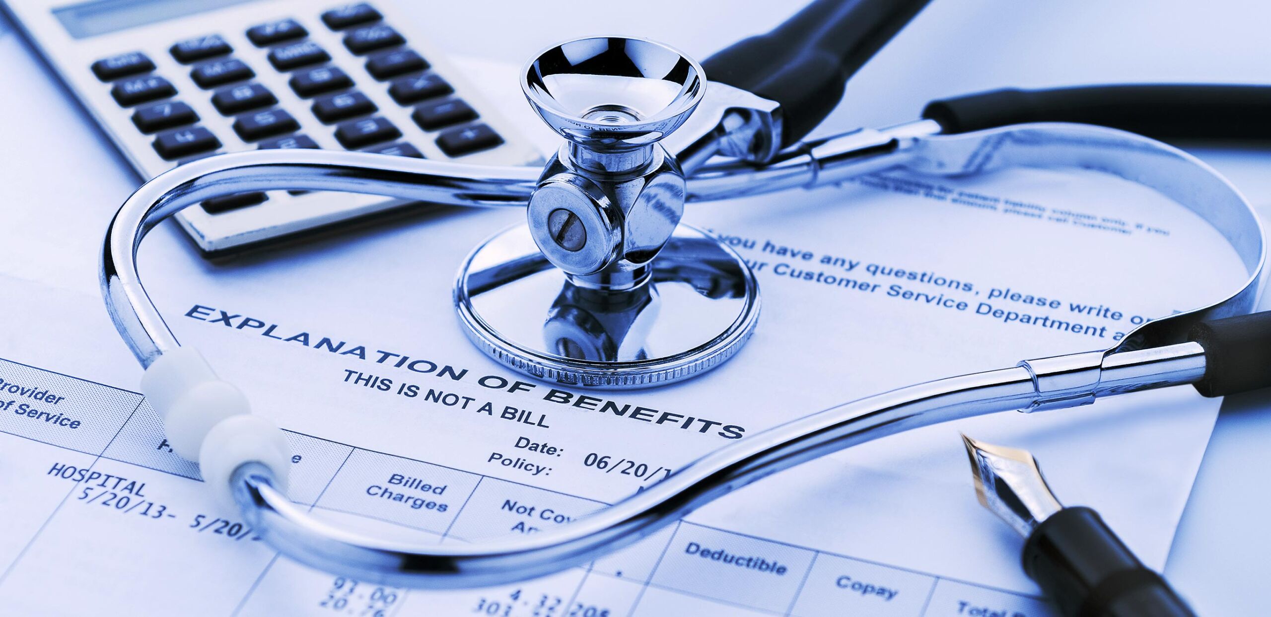 Calculator, stethoscope, and pen with Explanation of Benefits statement, Billing and Financial Services, Cooley Dickinson Hospital, 30 Locust Street, Northampton, MA 01060.