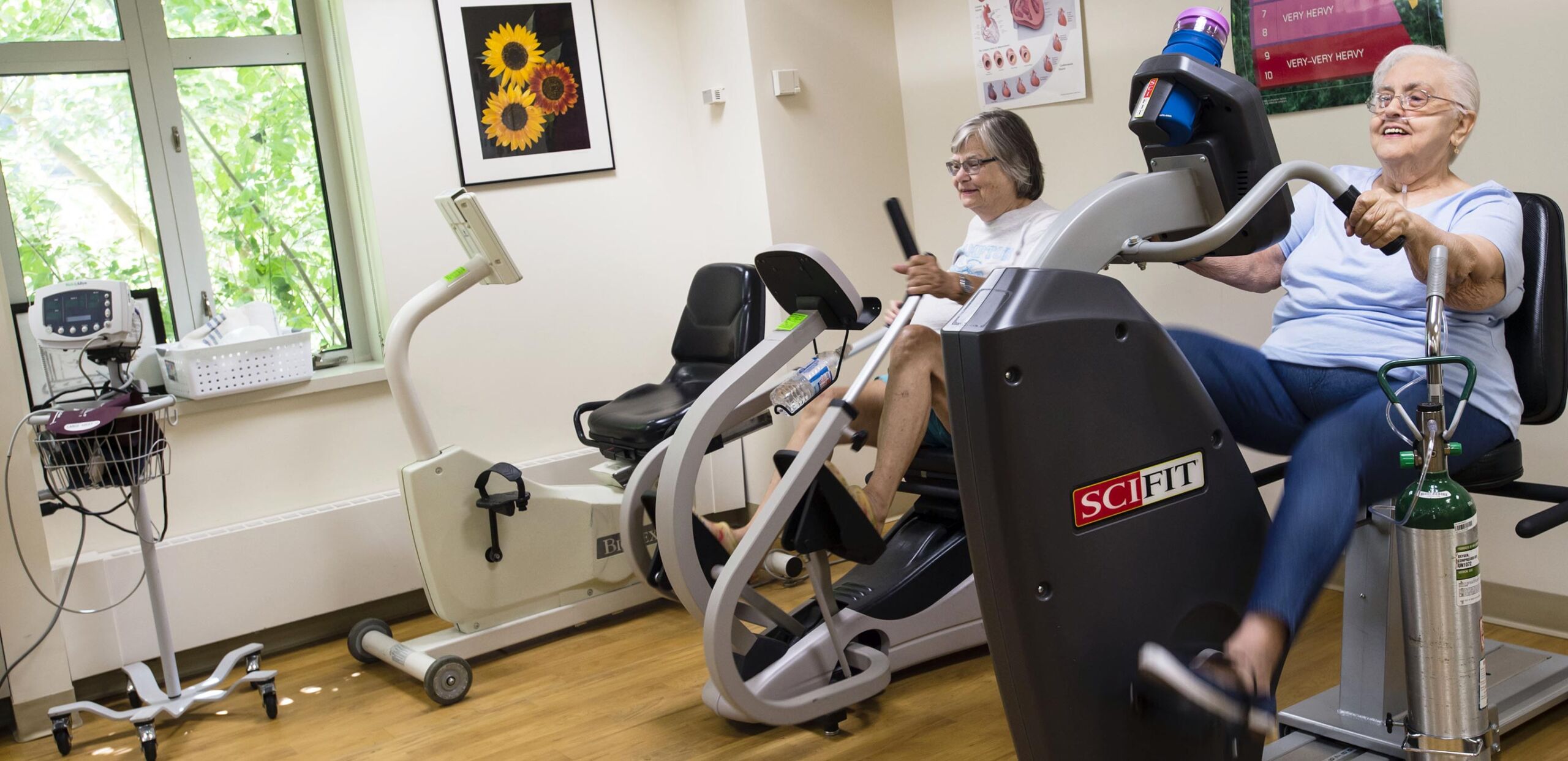 Two women using stationary exercise equipment in the Cardiopulmonary Rehabilitation Center at Cooley Dickinson Hospital, Northampton, MA 01060.