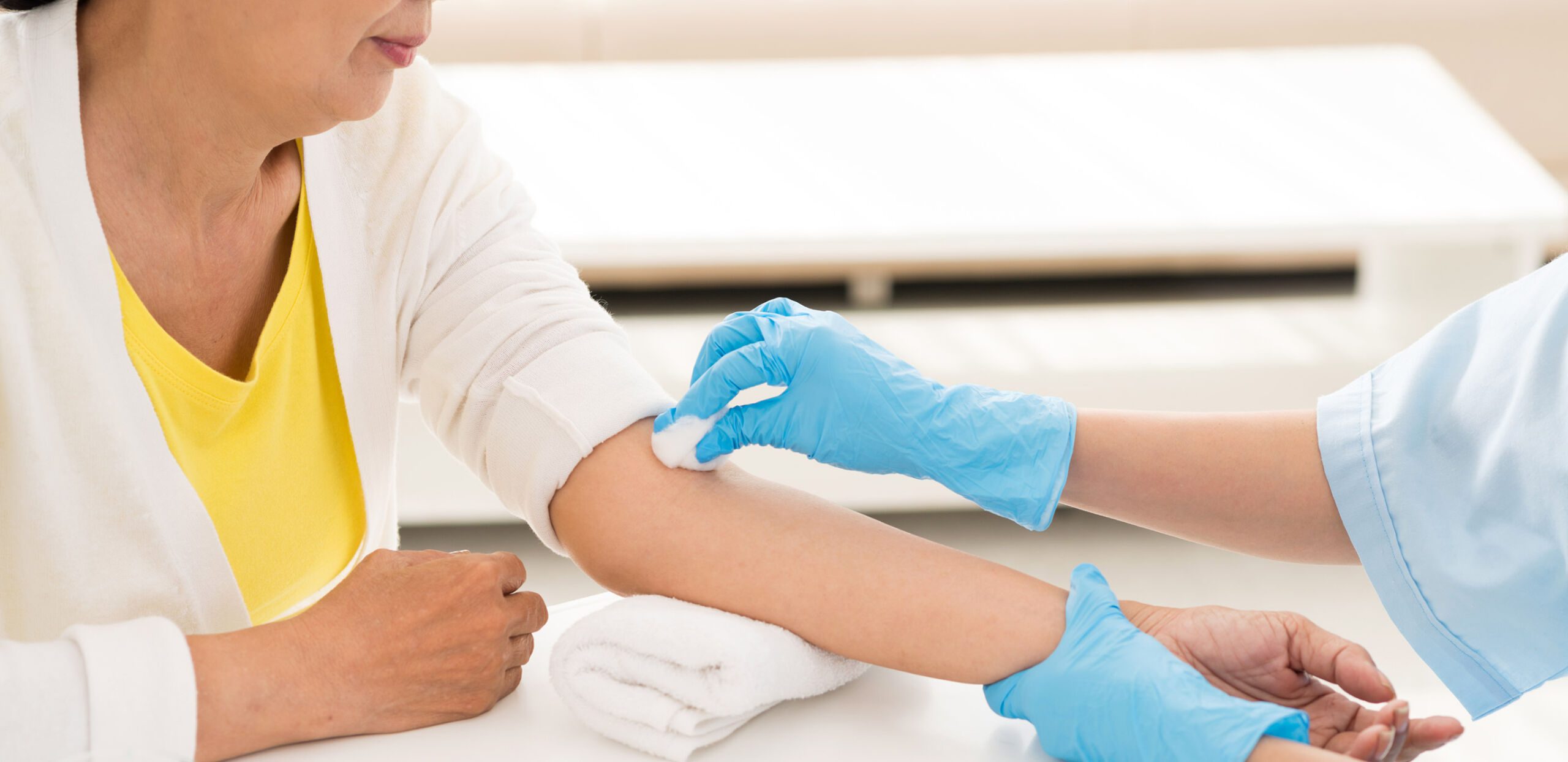 Technician prepares patient arm for blood draw at an anticoagulation clinic, Cooley Dickinson Medical Group Hampshire Cardiovascular Associates, Northampton, MA 01060.