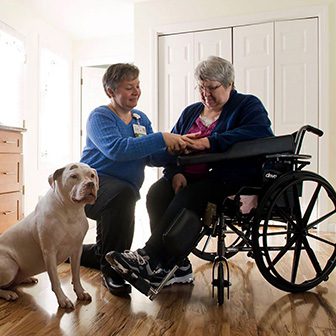 Visiting nurse talks with female client in wheelchair in her home, Cooley Dickinson Medical Group VNA & Hospice, Northampton, MA 01060.