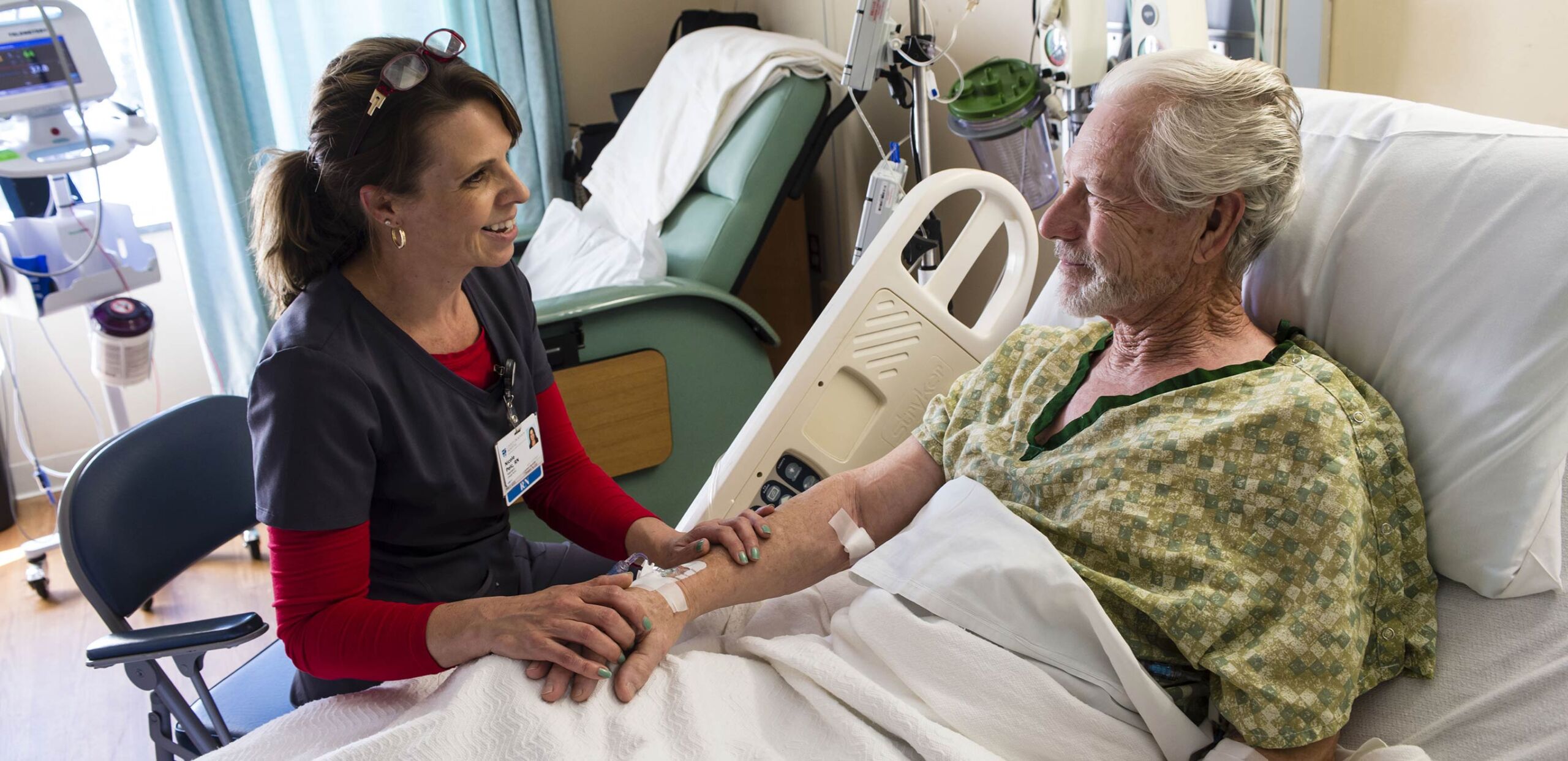 Nurse talks patient in his bed at Cooley Dickinson Hospital, 30 Locust Street, Northampton, MA 01060.