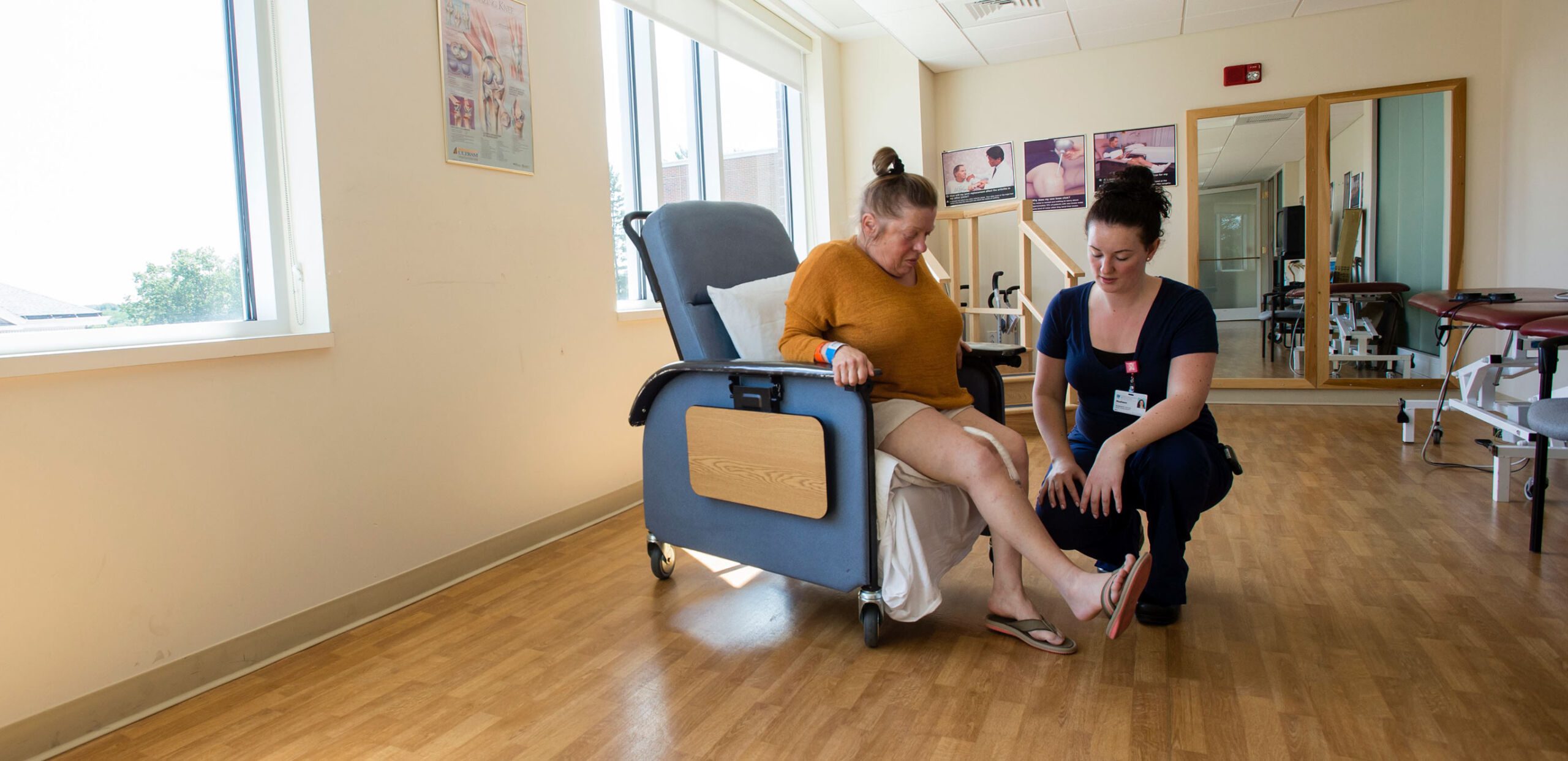Physical therapist talks with female patient, Cooley Dickinson Medical Group Orthopedics and Sports Medicine, West Hatfield, MA 01088.