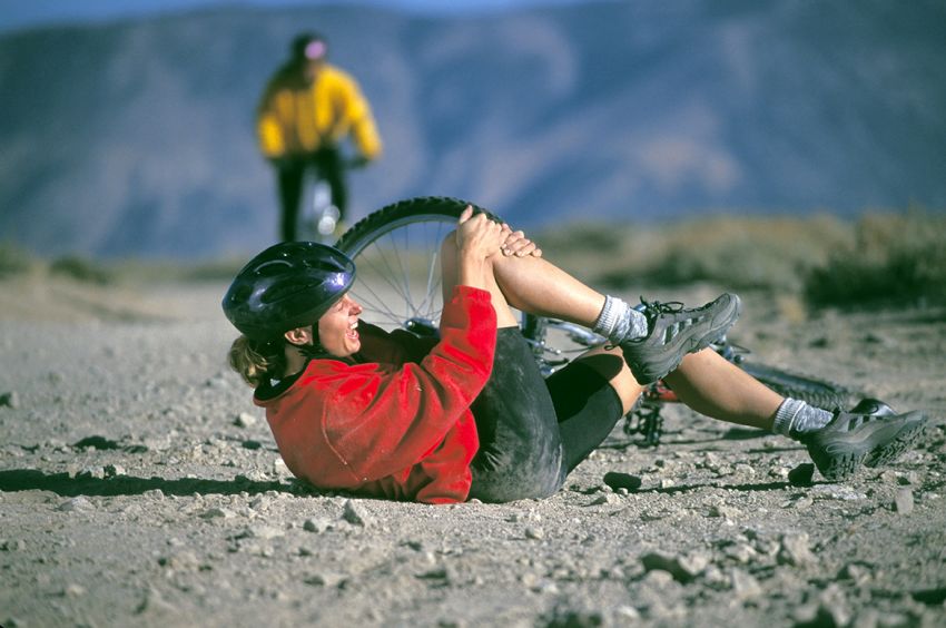 Woman clutching knee after falling from bike, Cooley Dickinson Medical Group Orthopedic Injury Clinic, West Hatfield, MA, 01088.