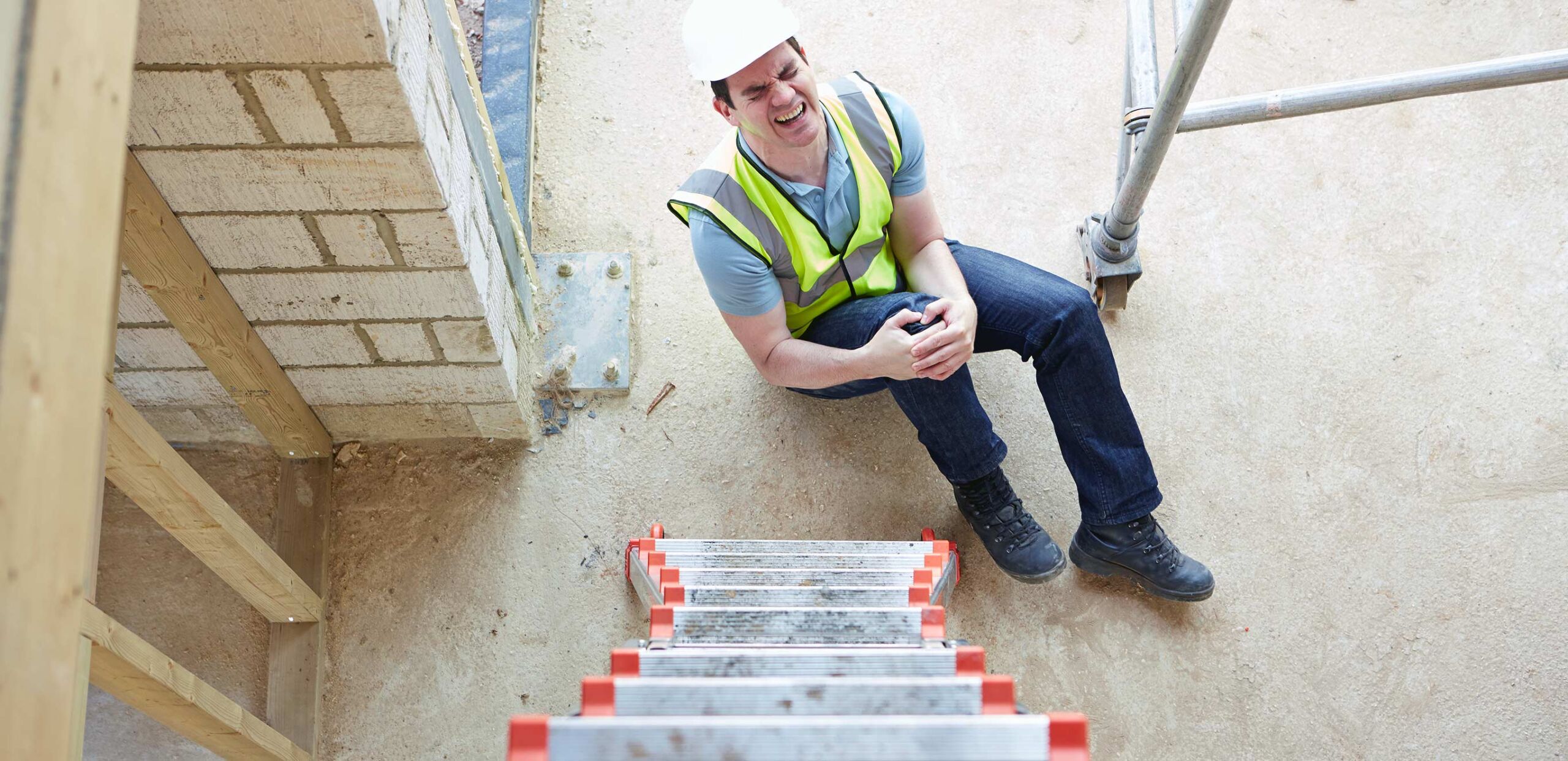 Male worker clutches knee after falling from ladder, Orthopedic Injury Clinic at Cooley Dickinson Medical Group Orthopedics & Sports Medicine, West Hatfield, MA 01088.