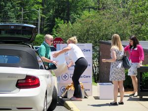 Steve Lewis and Tracy Stearns of Steve Lewis Subaru unload boxes of care items for Cooley Dickinson cancer patients.