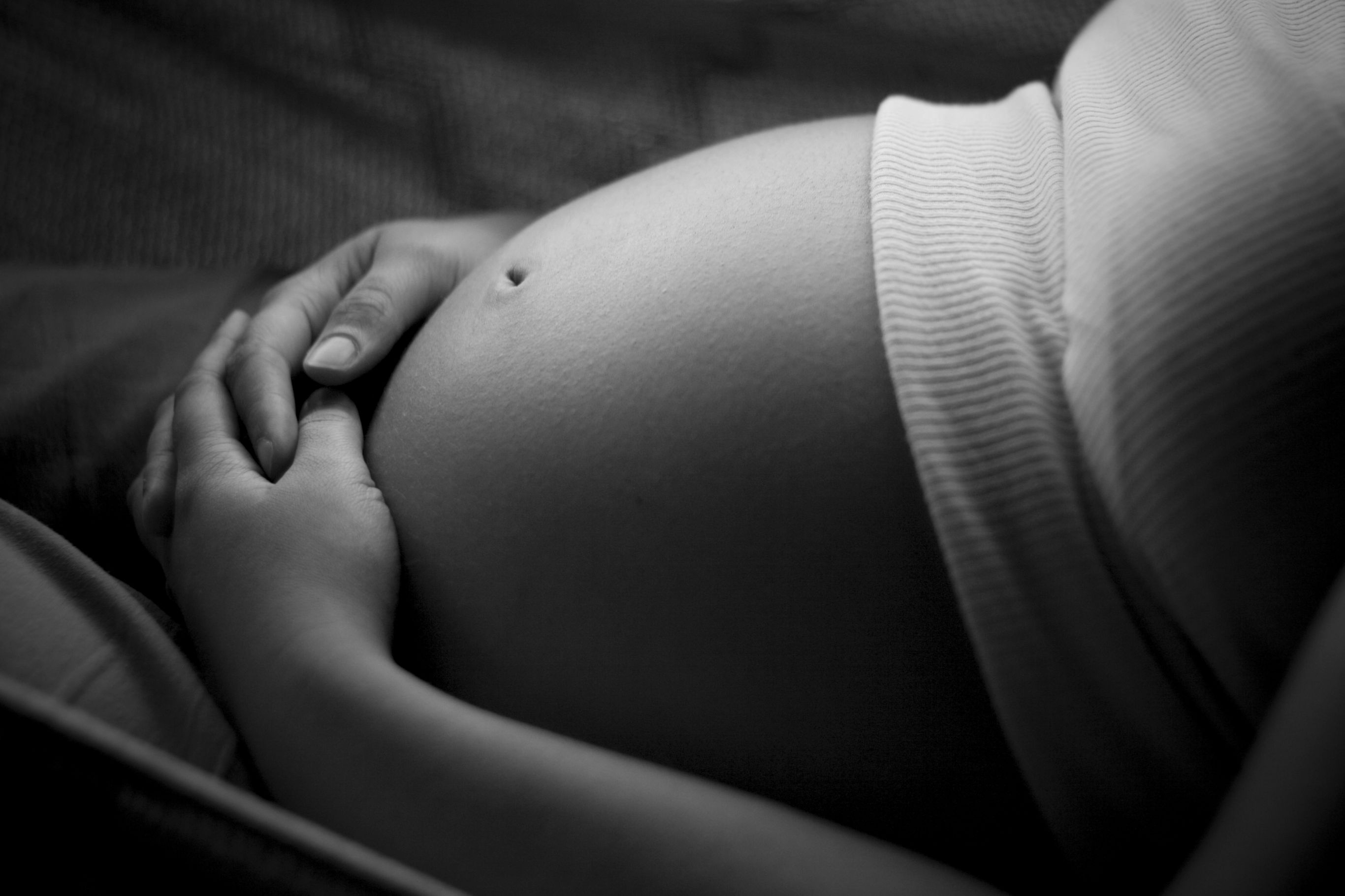 Black and white image of a pregnant stomach
