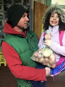 Maple Elementary School student June Halfacre and dad Jason receive their share of the School Sprouts Farm-to-School program's harvest-small-WEB