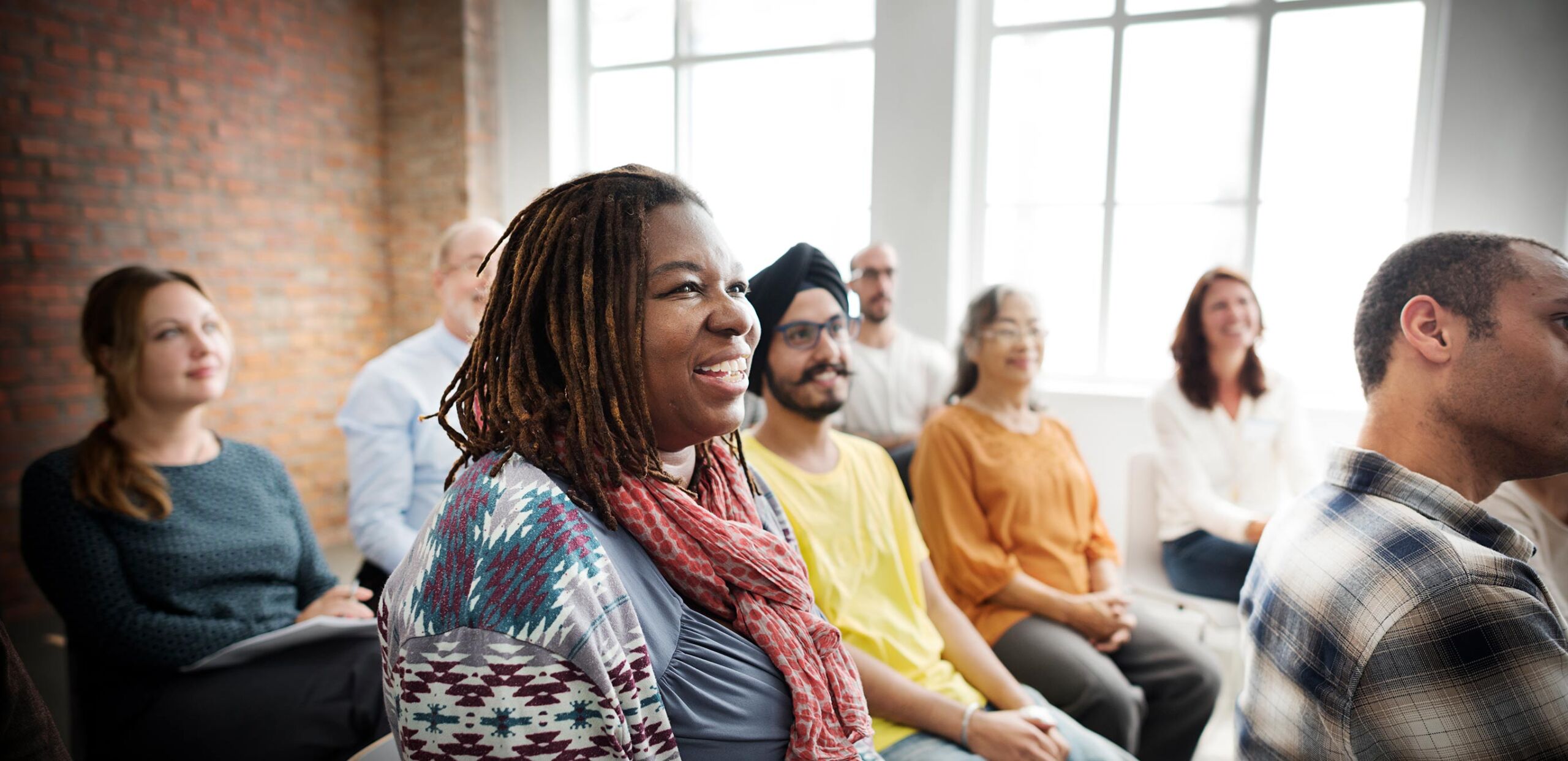 Group of diverse adults sitting in a room