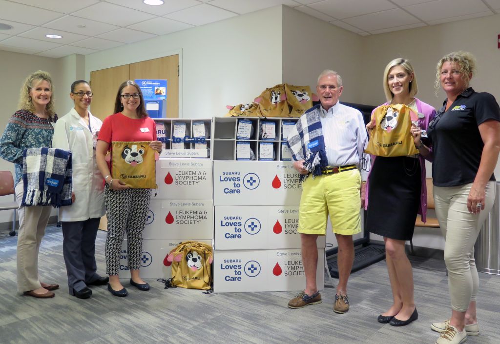 From left, Practice Manager Kelly Noonan, Clinical Nurse Manager Jennifer Ledoux, Sally Ekus from the Leukemia & Lymphoma Society, Steve Lewis from Steve Lewis Subaru, Director Caitlyn Lundberg, and Tracy Stearns, Steve Lewis Subaru