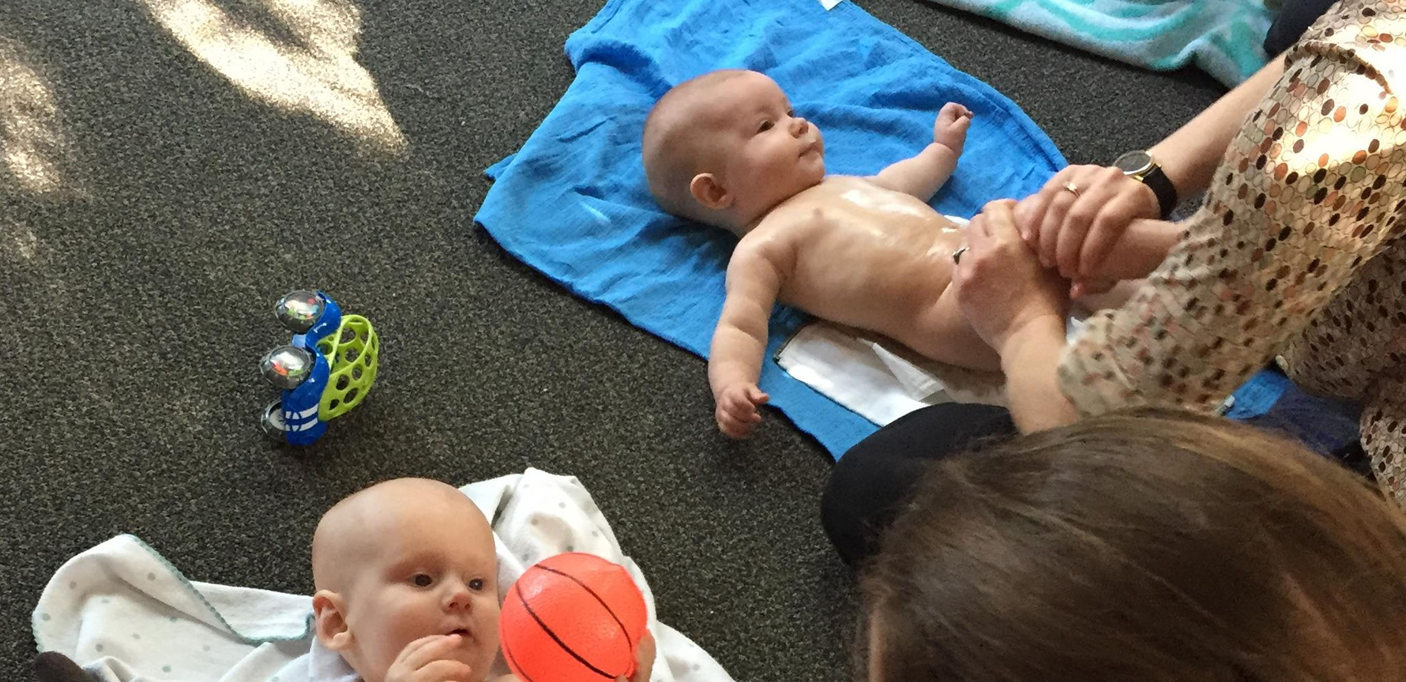 Infants lying on the floor during infant massage class