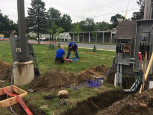 Kevin and David Glaude of Rhode Island-based DK Power begin the work of laying out where EV charging stations will live and preparing the wiring for the charging units, scheduled to be delivered in mid-August.