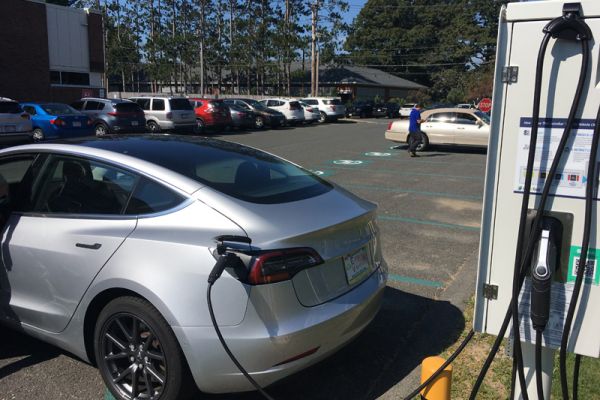 An early customer plugs in just hours after the EV charging stations went live.