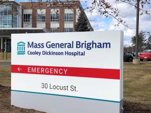 New signage at Cooley Dickinson Hospital showcases its further connection with Mass General Brigham.