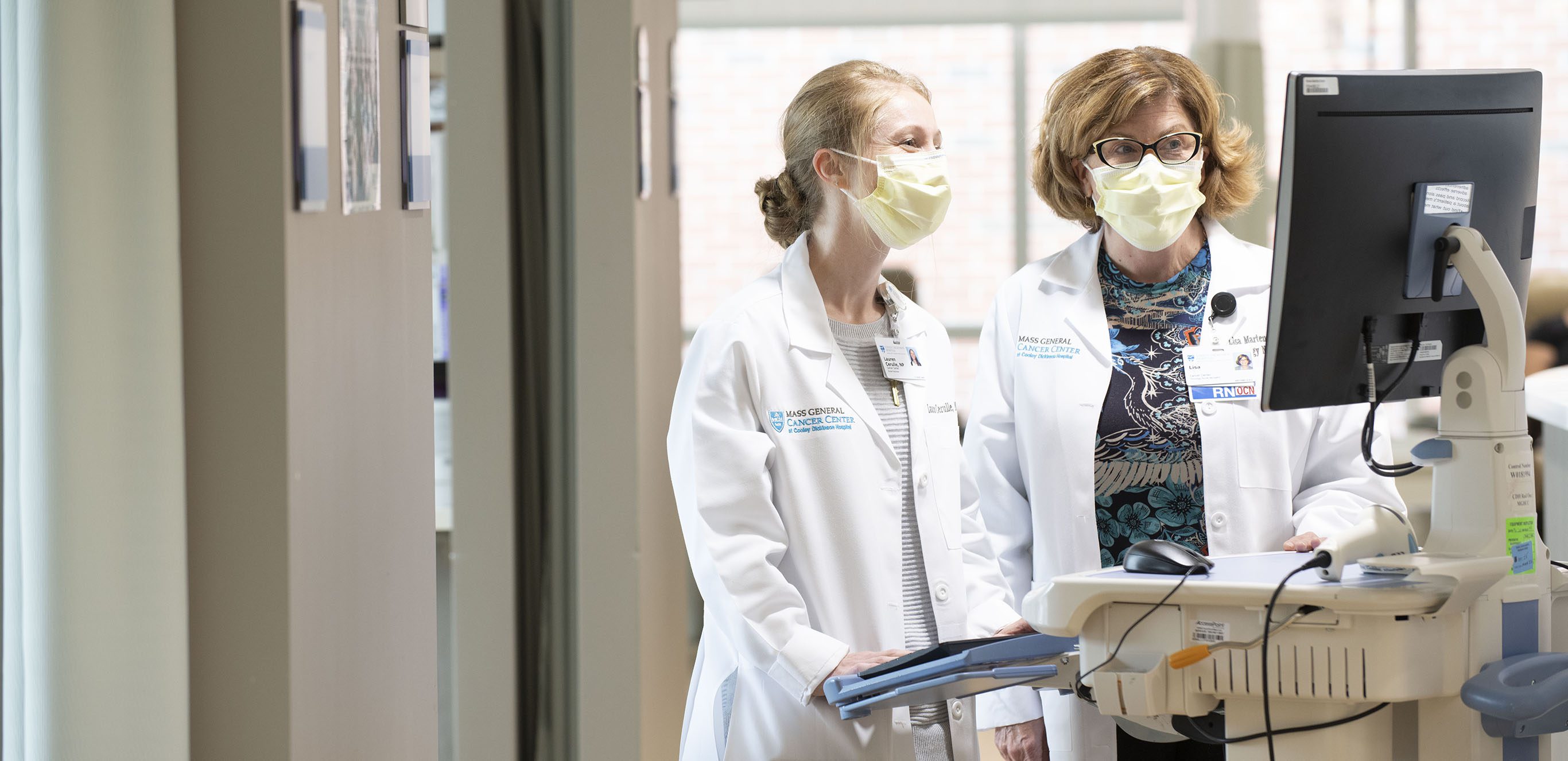 Cooley Dickinson doctors discussing a patient file on a computer