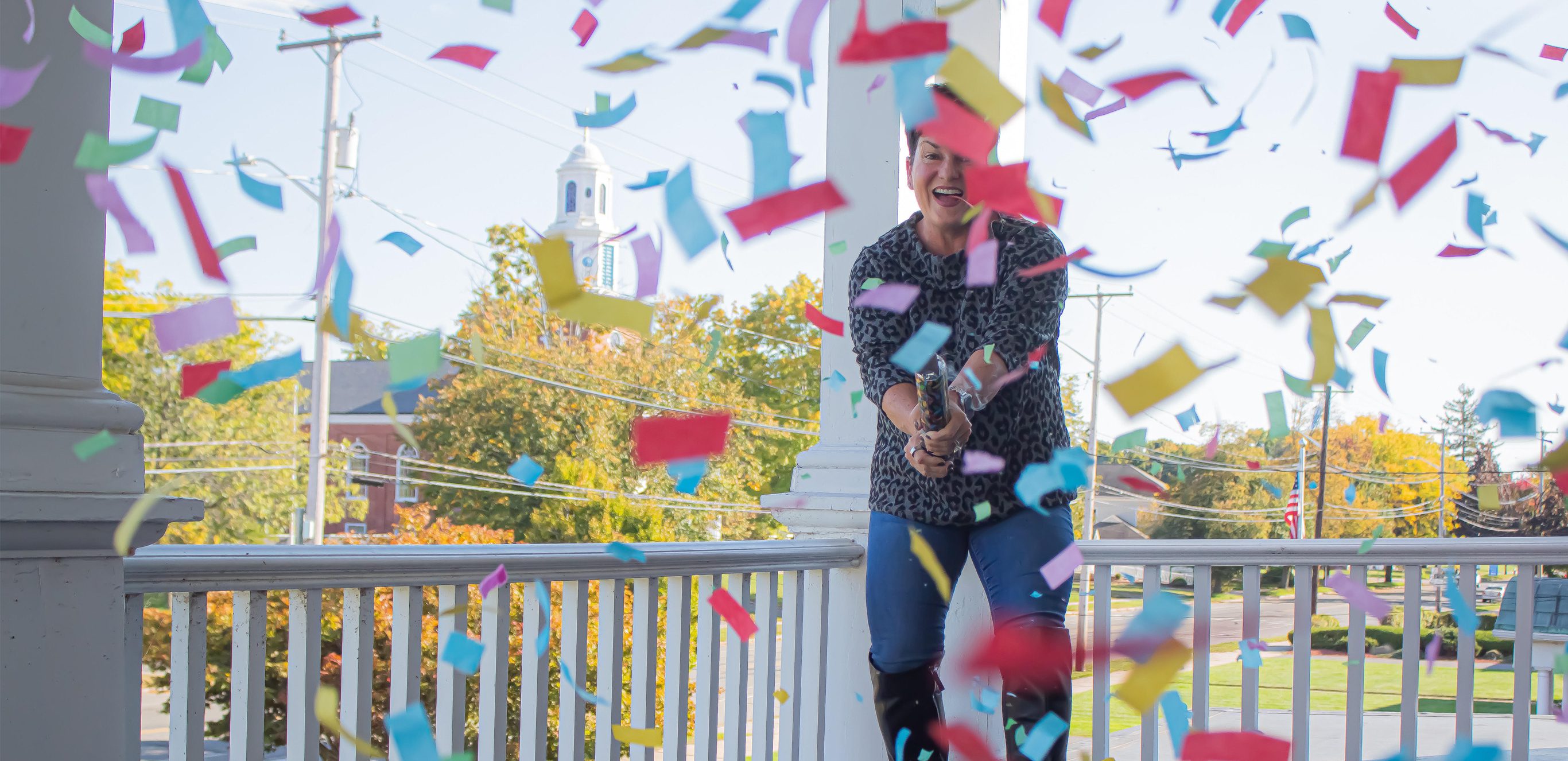 Author and financial advisor Amy Jamrog shooting a confetti cannon outside