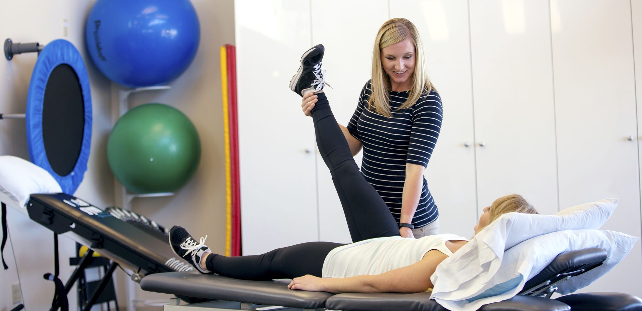 Physical Therapist working with a patient in a rehabilitation center.