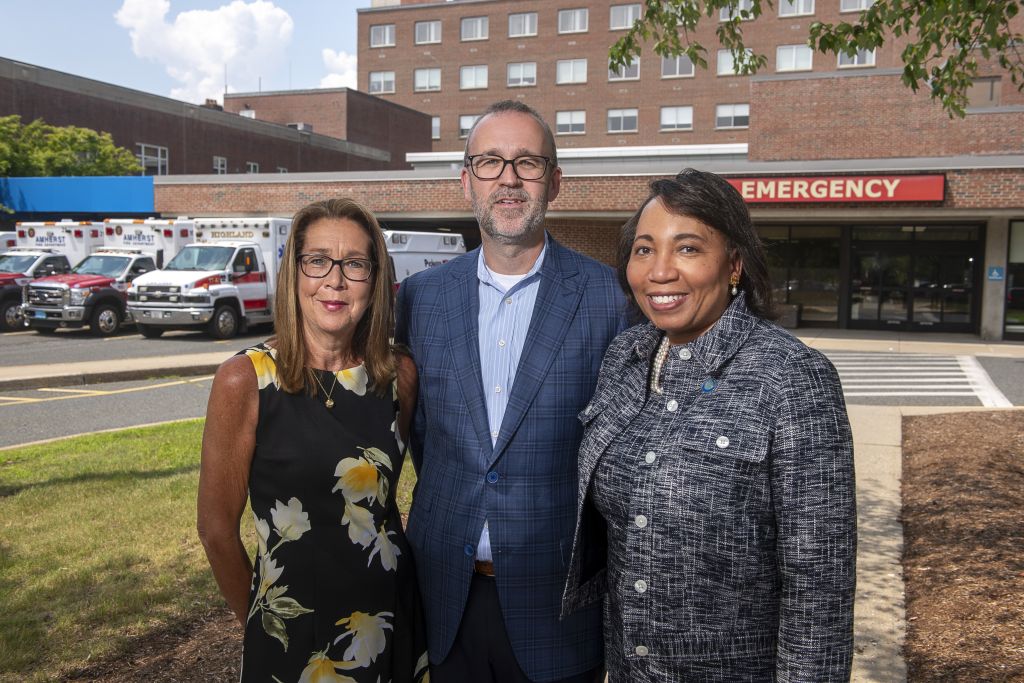 Two women and a main standing outside Cooley Dickinson Hospital