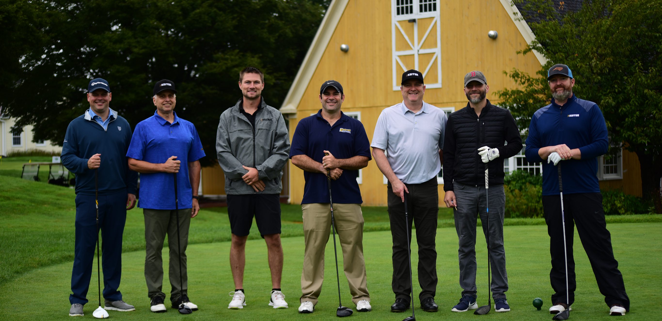 Group of golfers standing on a green.