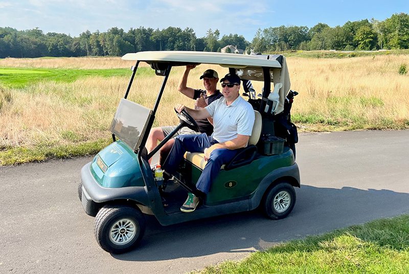 Two golfers in a golf cart