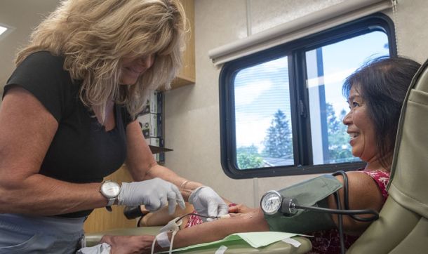 IV nurse drawing blood from patient